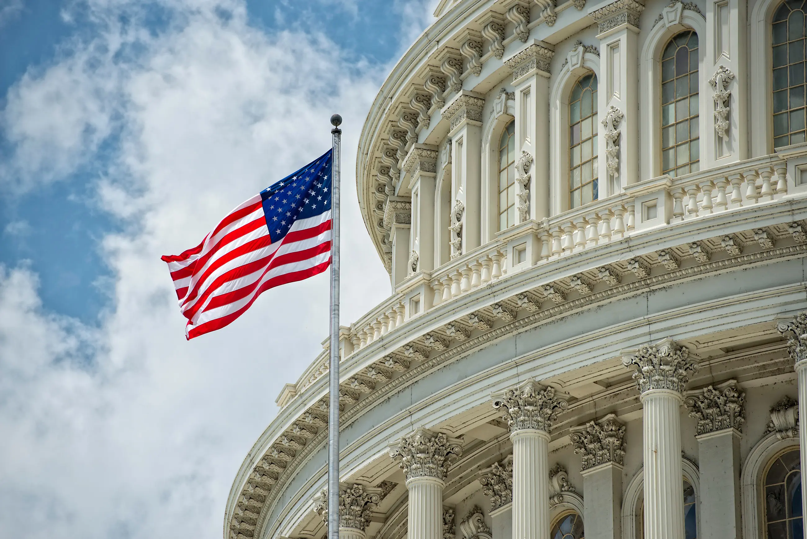 Washington DC Capitol dome detail with waving american flag